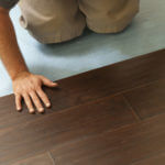 Man Installing New Laminate Wood Flooring