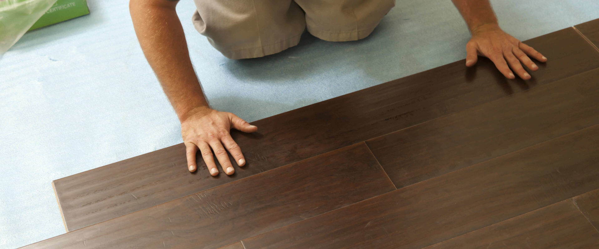 Man Installing New Laminate Wood Flooring