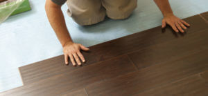 Man Installing New Laminate Wood Flooring